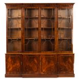A mahogany breakfront bookcase, the glazed doors with panel doors beneath,