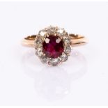 A ruby and diamond cluster ring, the central ruby to a surround of ten diamonds,