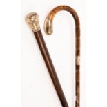 A silver mounted walking cane with hoop handle and an ebonised walking stick with a silver top