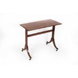 A Regency mahogany table, the rectangular top on plain rectangular end standards and splay feet,