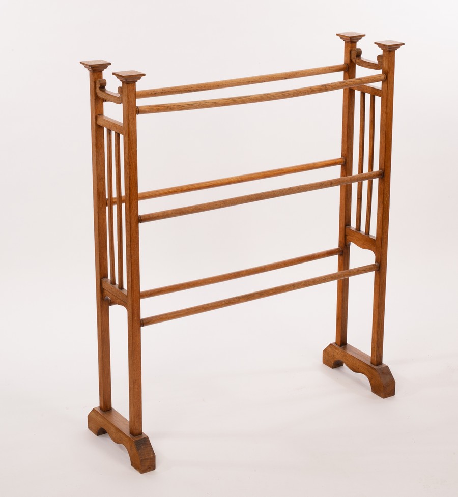 An Arts & Crafts oak towel rail,