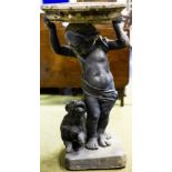 A stone bird bath with lead putto and dog base,