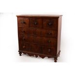 A Victorian mahogany chest of drawers with a shaped apron,