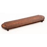 A fruitwood cribbage board, the rounded ends inlaid batwing patera, with pegs,