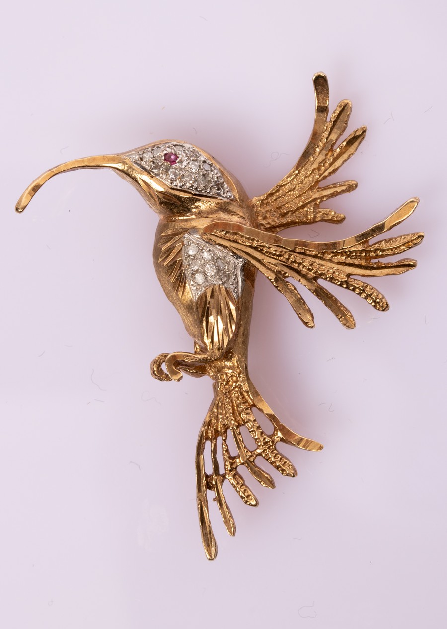 A gem set novelty brooch modelled as a hummingbird with ruby eye and diamond body,