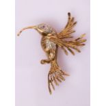 A gem set novelty brooch modelled as a hummingbird with ruby eye and diamond body,
