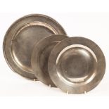 A pair of pewter plates, 23cm diameter and a larger dish,
