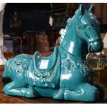 A Chinese style blue glazed seated figure of a horse