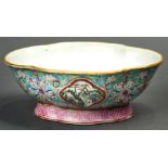 A Chinese Famille Rose turquoise ground pedestal dish