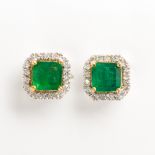 A pair of emerald, diamond and eighteen karat white gold stud earrings