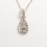 A diamond and fourteen karat white gold pendant necklace