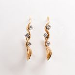 A pair of diamond and eighteen karat gold pendant earrings