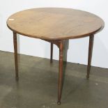 An American Primitive folding table having a circular ash top