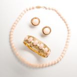 A group of angel skin coral and fourteen karat gold jewelry