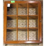 A diminutive wall mount vitrine