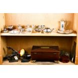 Two shelves of silver and wooden decoratives