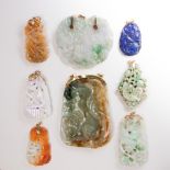 A group of carved jade or lapis lazuli pendants