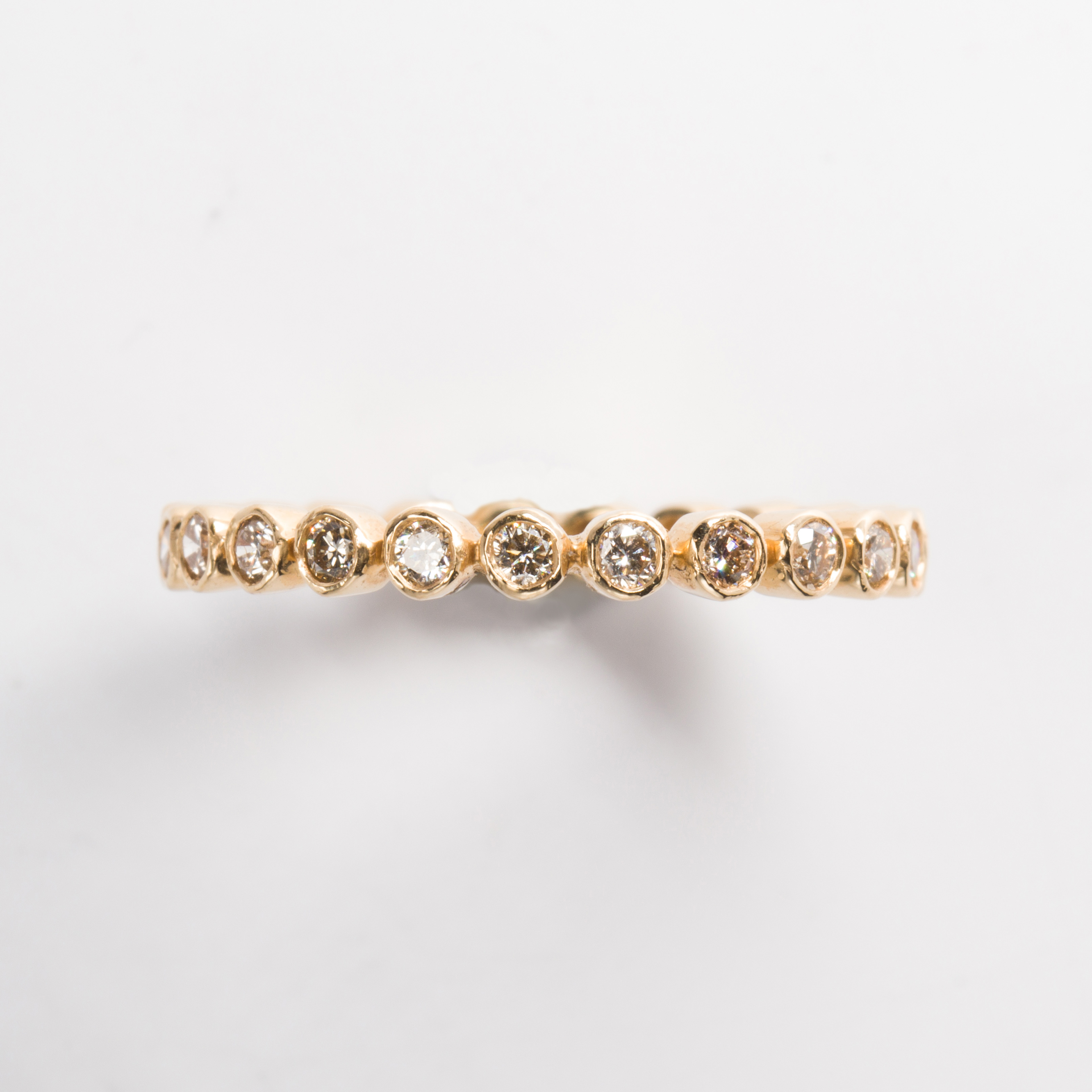 A diamond and eighteen karat gold band ring