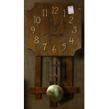 An Arts and Crafts oak wall clock