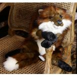 A plush animal of a reclining fox