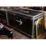 Black enameled instrument gear road tour case having chrome hardware above a wheeled base