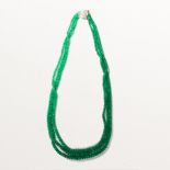 An emerald, diamond and fourteen karat white gold torsade necklace