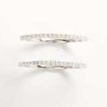 A pair of diamond and eighteen karat white gold band rings