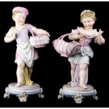 (lot of 2) A group of German porcelain figural groups depicting a boy and girl