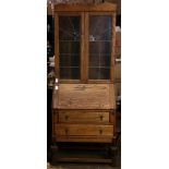 Oak secretary having leaded glass doors