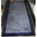Chinese Baotou cobalt ground rug with allover blossom design