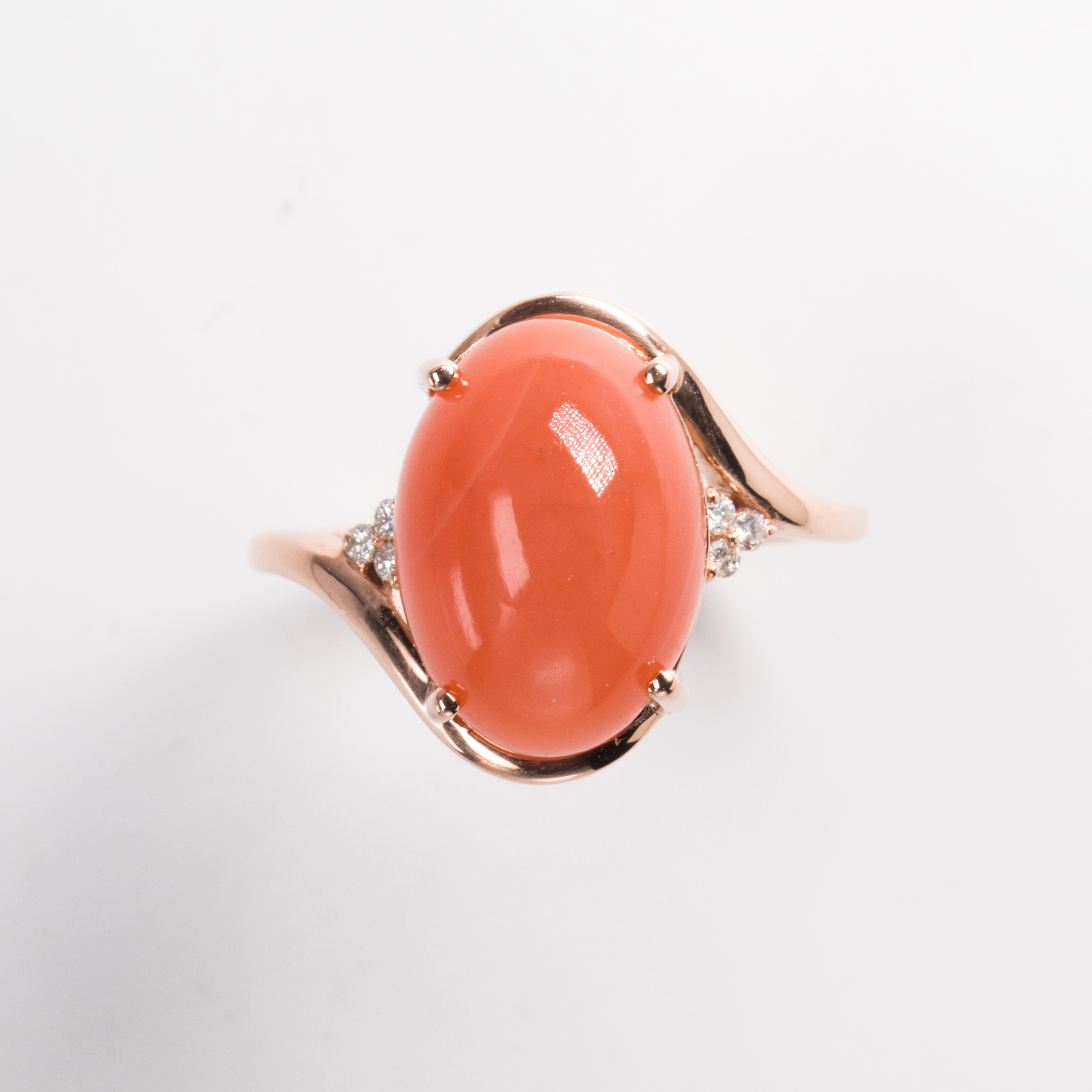 An orange moonstone and fourteen karat gold ring