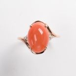 An orange moonstone and fourteen karat gold ring