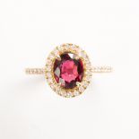 A red spinel, diamond and fourteen karat gold ring