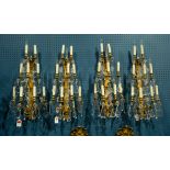 (lot of4) A suite of gilt bronze and crystal tiered candelabra, each having tear drop mounts