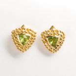 A pair of peridot and fourteen karat gold earrings