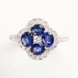 A sapphire, diamond and fourteen karat white gold ring