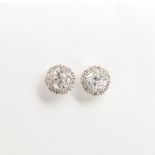 A pair of diamond and eighteen karat white gold stud earrings