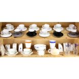 Two shelves of espresso cups and salt shakers