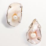 A pair of artisanal pearl and silver rings