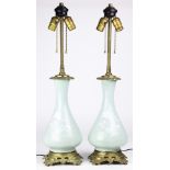 A pair of gilt bronze mounted pate sur pate porcelain lamps