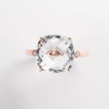 A colorless quartz and fourteen karat rose gold ring