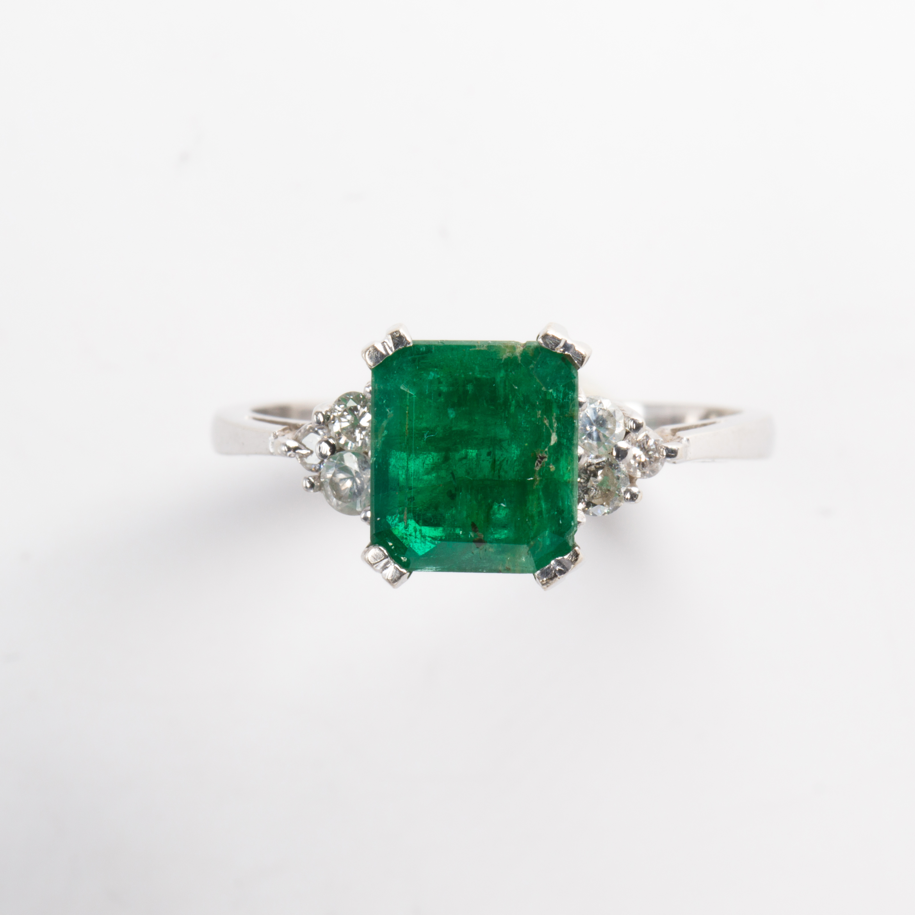 An emerald, diamond and fourteen karat gold ring