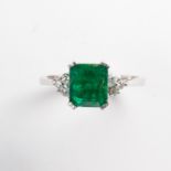 An emerald, diamond and fourteen karat gold ring