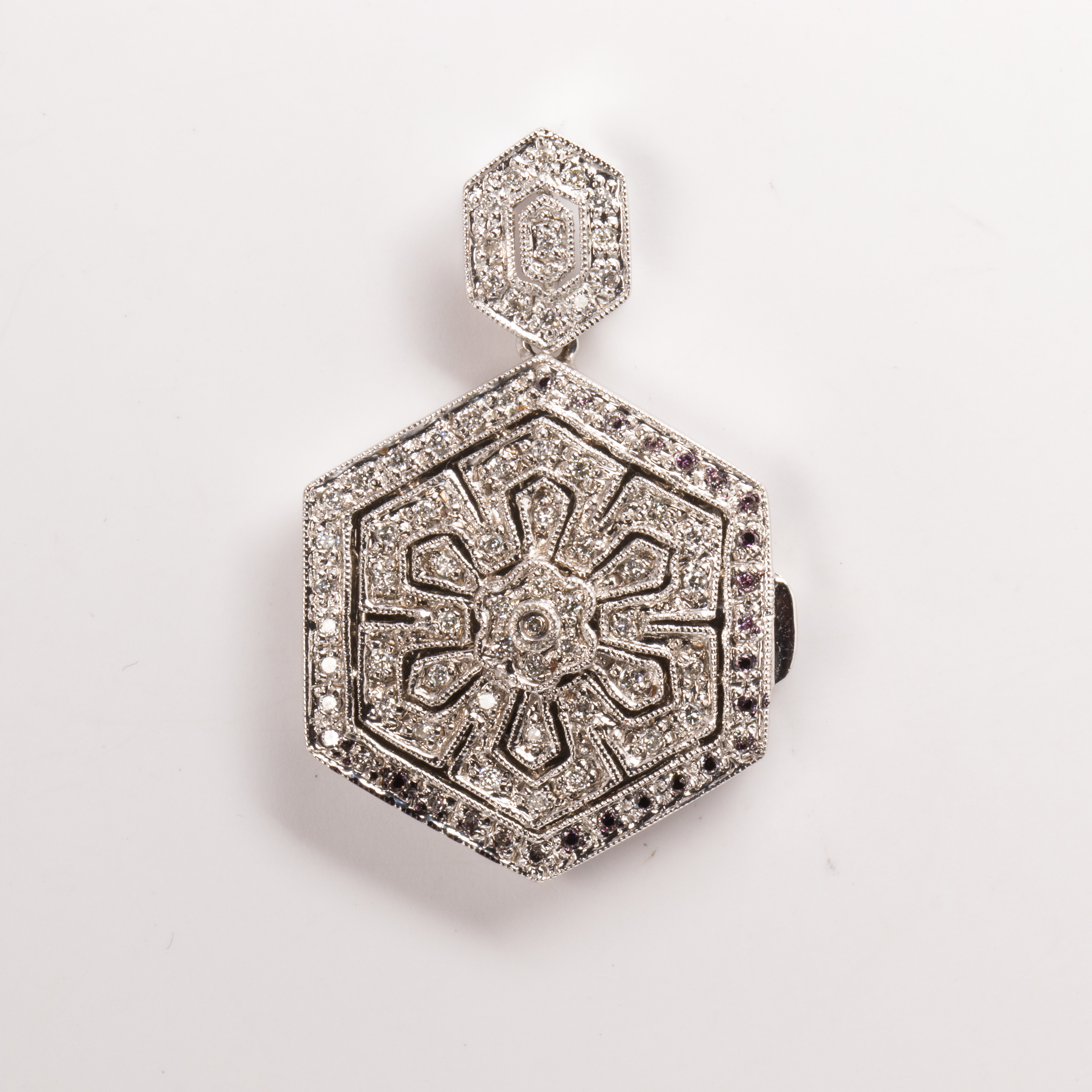 A diamond and fourteen karat white gold locket pendant
