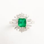 An emerald, diamond and eighteen karat gold ring