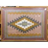 Navajo wool rug with peach ground, mounted in frame