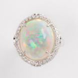 An opal, emerald, diamond and fourteen karat white gold ring