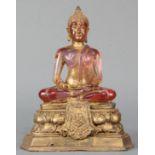 Chinese gilt heightened amber seated Buddha on a lotus wood base