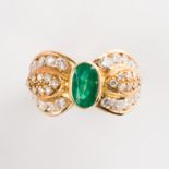 An emerald, diamond and eighteen karat gold ring