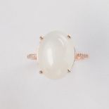 A moonstone and fourteen karat rose gold ring